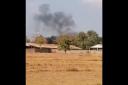 Smoke rises above the base following the blast (Chim Sothea/AP)