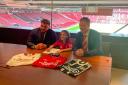 Faris Khan signing his contract at Manchester United