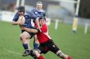 Skipton's Malcolm Willsher clings onto Yarnbury’s Al Bowden as he launches a determined attack