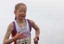 A mud-covered Amelie Lane won the under-15 girls' Withins Skyline race. Picture: Geoff Thompson