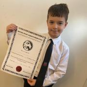 Luke Greenwood with his 1st dan karate certificate