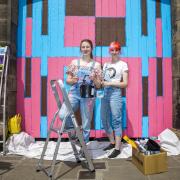by artists Beth Sculpher (left) and Sian Laura with one of their murals