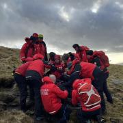 The CRO team carrying the casualty back off the fell