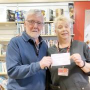 Bill Simpson is pictured with Denise Braham, manager of Skipton's British Heart Foundation Shop, receiving a cheque for £800