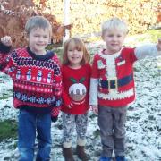 A trio of children at Settle CE Primary School show off their bright and colourful jumpers