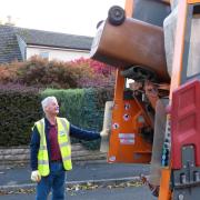 Cllr Chris Moorby empties a brown bin