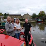 Aboard a narrow boat outside The Boat House is (left to right) bar owner Ian Clarke, Annie Fawcett, Ian's daughter Stephanie and bar manager, John "Spike" Garton.