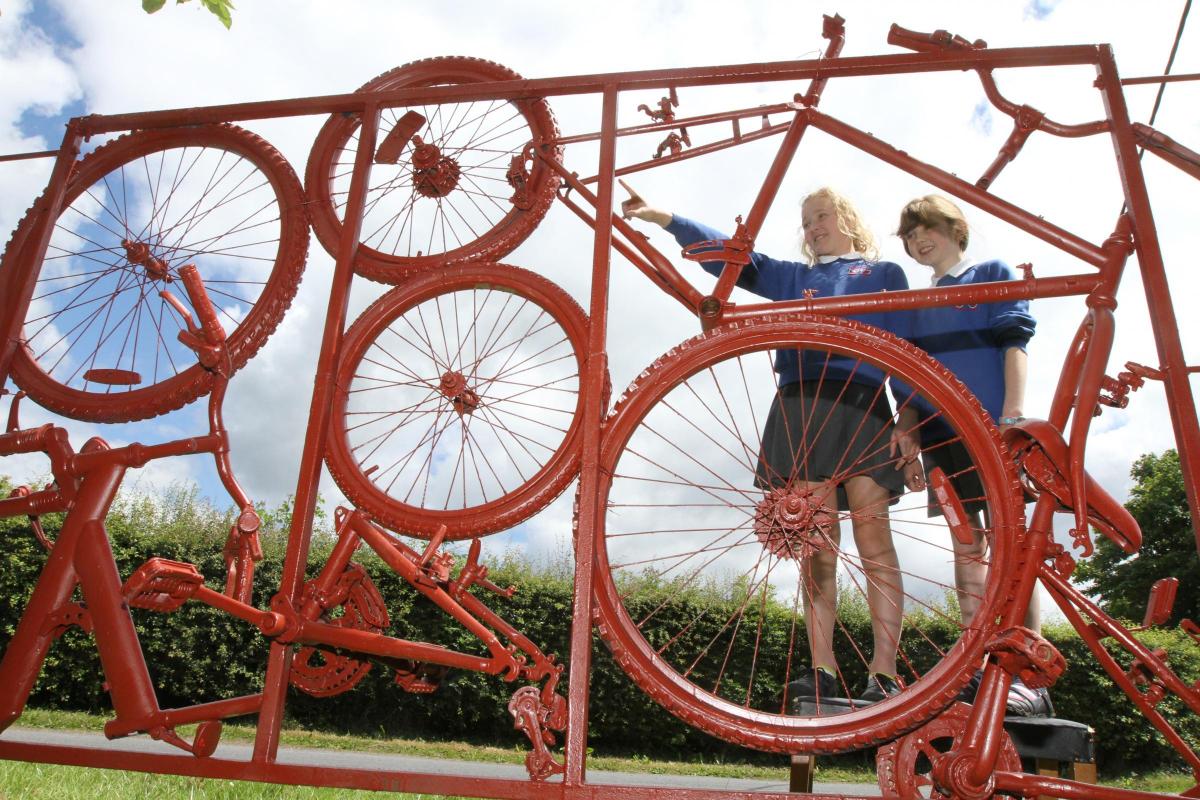 Boyle and Petyt School Pupils Ruby Gray and Lucy Flesher view the new Tour De France-inspired sculpture entitled Poetry In Motion
