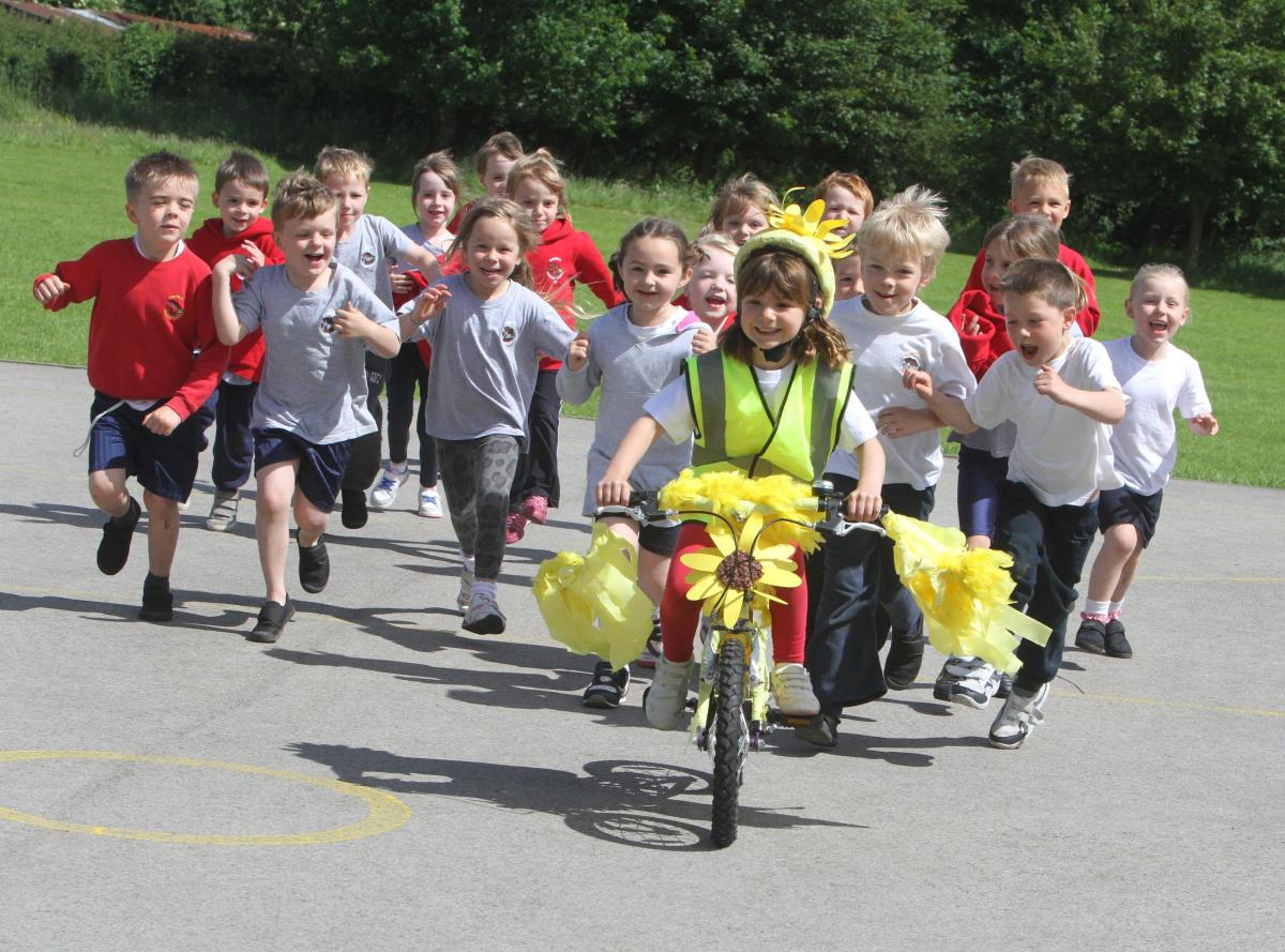 Cononley Primary School pupil Milly Timbers brings to school her yellow Tour De France Bike