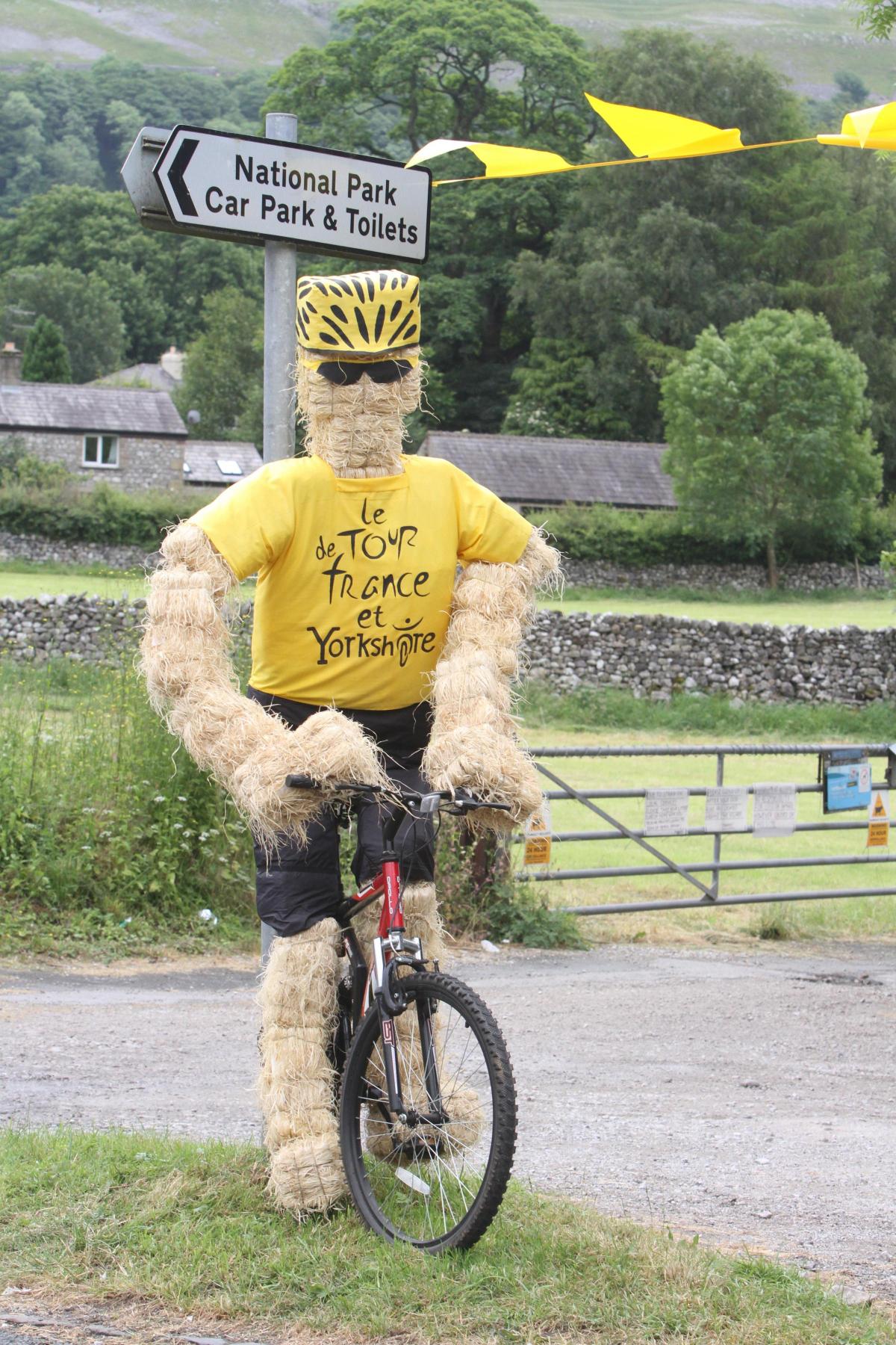 A straw cyclist welcomes people to Kettlewell