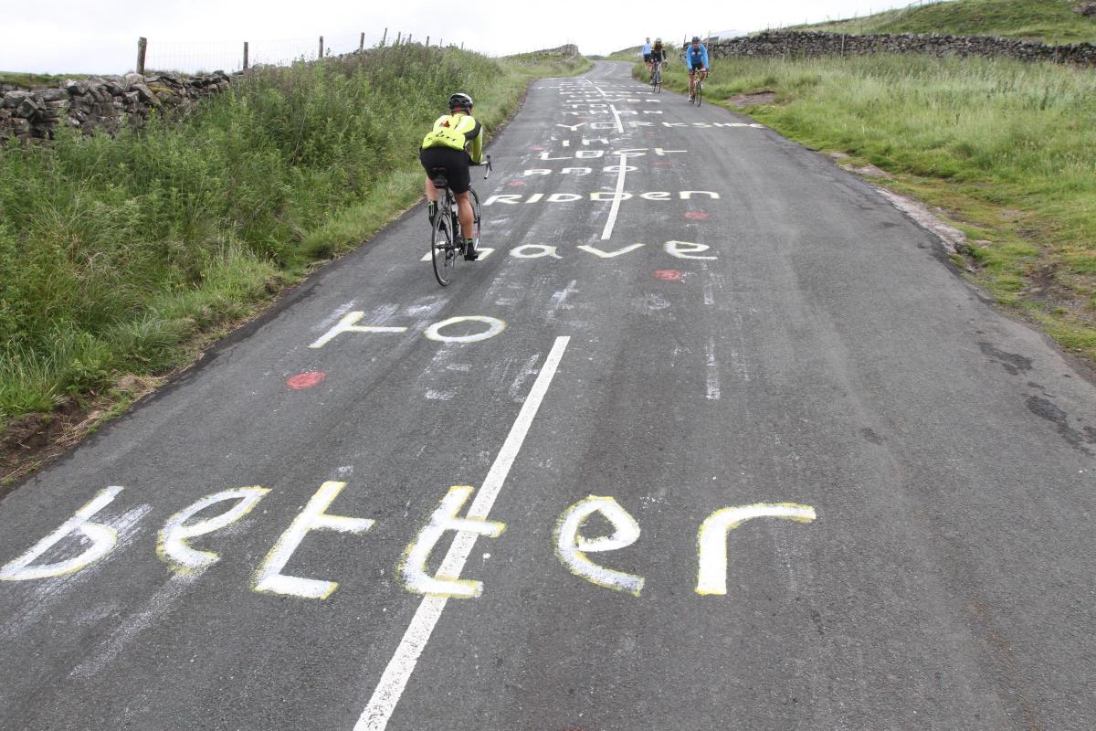 Markings on a Dales road encourage riders up the slope