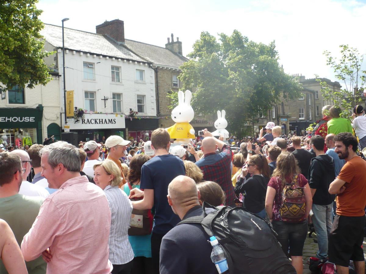 Crowds in Skipton watching the Tour 'caravan' passing through on Saturday before the arrival of the cyclists 