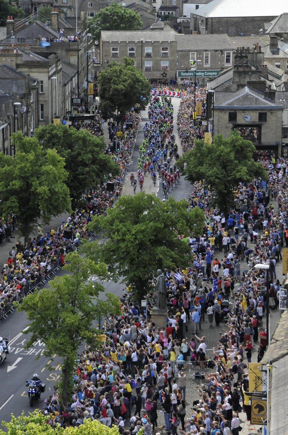 The view from the tower of Holy Trinity Parish Church of the Tour riders in Skipton's High Street. 