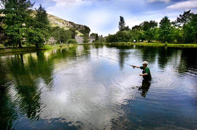 Kilnsey Crag is one of the most spectacular sights in the Yorkshire Dales and can be seen in the background of this picture by Craven Herald photographer Stephen Garnett, showing a fisherman on Kilnsey Lake