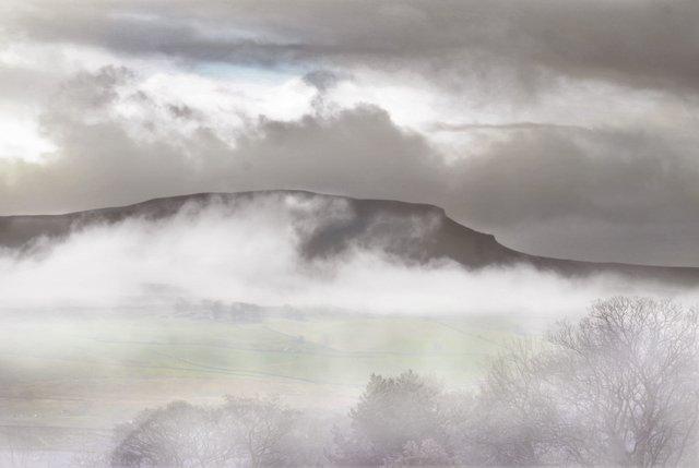 Penyghent, one of the Three Peaks, stands proud among the low cloud and mist in this photograph by Stephen Garnett.