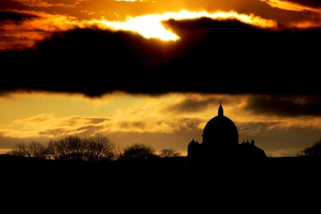 Giggleswick Chapel, captured in silhouette against a fading sun
