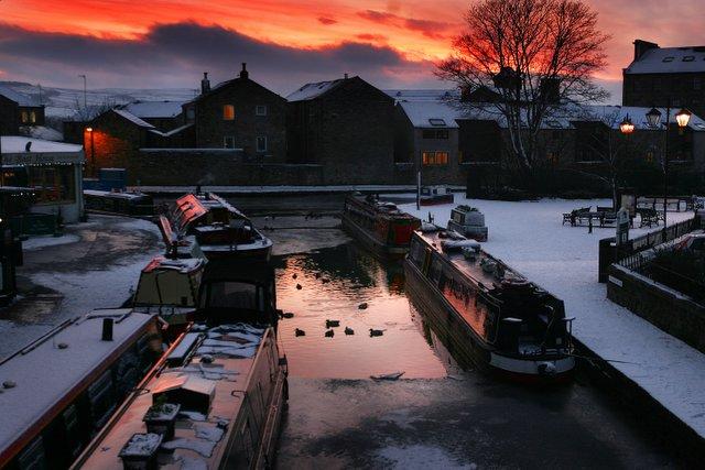 The sun sets over an icy canal at Skipton 