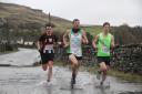 Mathew Cardus of Settle Harriers, right, won the Settle Half Marathon on Sunday. The runners are pictured at Helwith Bridge, Austwick.