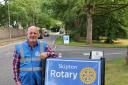 Rotary President David Newall with signage on The Bailey