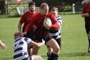 Skipton's (Red) Hamish Munro drives the ball forward. Pic: Georgie Green
