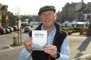 Peter Ellwood with his book at the top of Skipton High Street