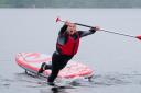 Liberal Democrat Leader Sir Ed Davey falls into the water while paddleboarding on Lake Windermere (Peter Byrne/PA)