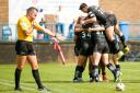 Referee John McMullen signals another Bulls try as scrum half Cory Aston is mobbed by team-mates after scoring against Oldham    Pictures: Simon Davies