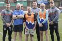 Cougars players welcome Mick Riddiough, second left, 
Nick Pyrah, middle, and Nigel Moscardini, second from right, after the trio had run to the ground from Odsal Stadium to raise funds for MNDA  Picture: Charlie Perry