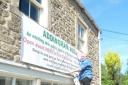 Cllr Brady and Library Trustee, Carol Hindle, put a banner up on the Old School to advertise the opening event