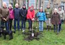 Chair of trustees, Pat Taylor, with spade, and friends and supporters of Settle Pool