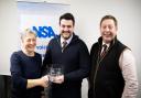 Rob Claughton, centre, receives his NSA Northern Region award from the NSA’s Viv Lewis, joined by treasurer and CCM auctioneer Ted Ogden.