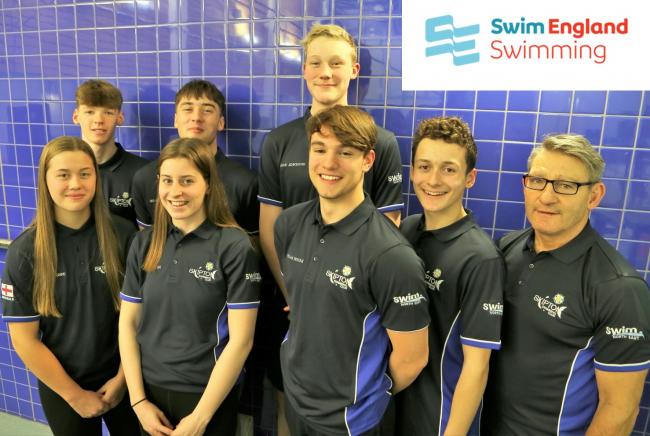 Seven of the swimmers pictured here with Head Coach Ian Scrivin.