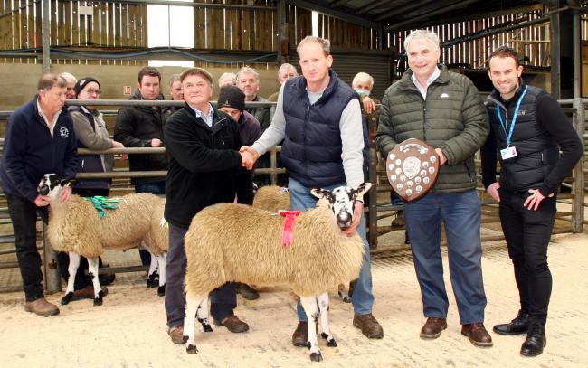 Joe Throup with his Addingham Sheepbreeders’ charity lamb champion, being congratulated by co-judge John Stott, joined by fellow judge Thomas Binns and Manorlands’ fundraiser Adam Brunskill, right.