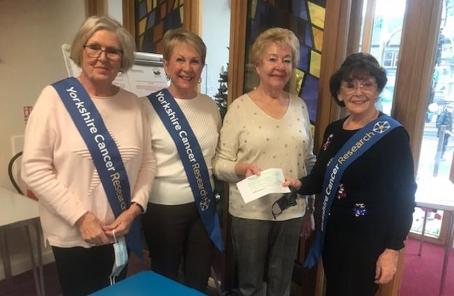 Rosalie Holroyd, 2nd right, president of Skipton Soroptimists, hands a cheque to Yorkshire Cancer Research