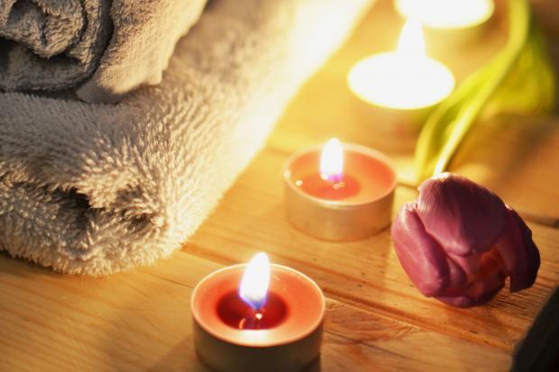 Craven Herald: A pile of towels, candles and a tulip. Credit: Canva