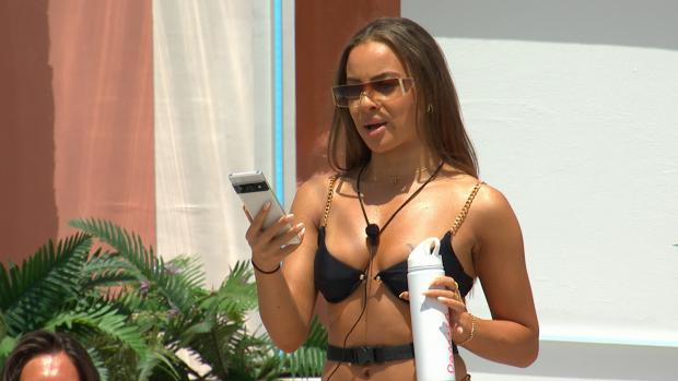 Craven Herald: Danica gets a text as Love Island continues tonight at 9pm on ITV2 and ITV Hub. Episodes are available the following morning on BritBox. Credit: ITV