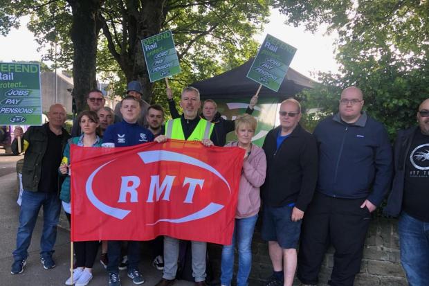 Rail workers on a picket line on June 21