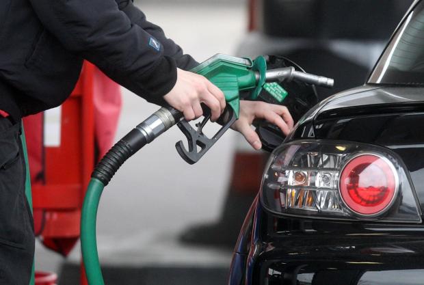 Craven Herald: Someone using a fuel pump at a petrol station (PA)