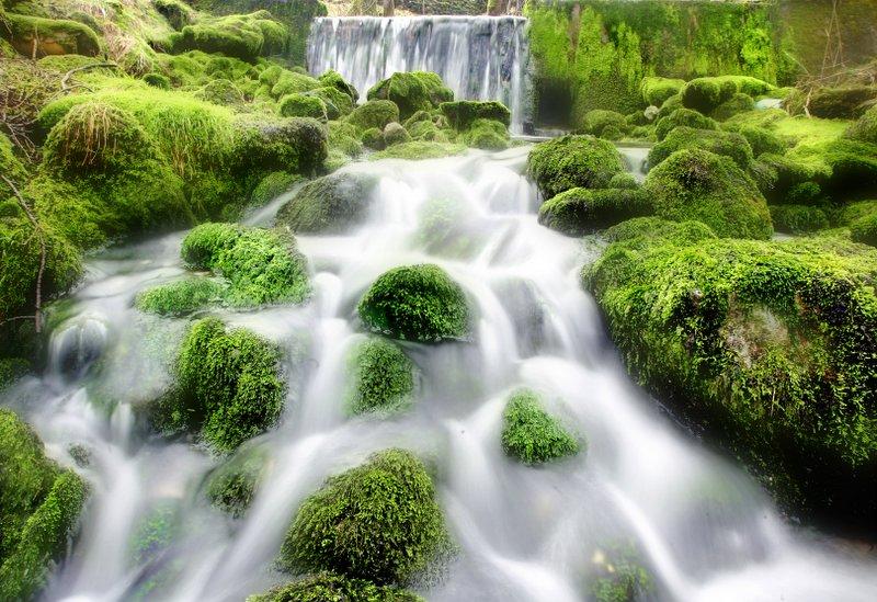 The ghost-like waters of Sykes Beck Dam cascade over the moss-covered rocks in this scene in Kilnsey.