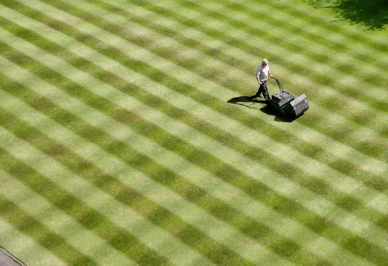 Groundsman David Robinson cuts a chequer-board effect on the front lawn at Skipton Castle 