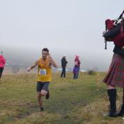 Mark Buckingham salutes the piper on his way to winning the Auld Lang Syne race. Picture: Dave Woodhead