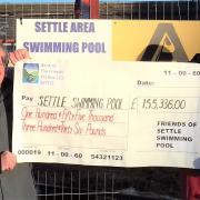 Friends chairman Alan Smith presents Pool trustee Pat Taylor with Friends contribution to the pool redevelopment project.