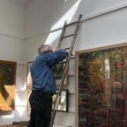 The artist’s son Ben Adams, preparing for the exhibition of his father’s work.