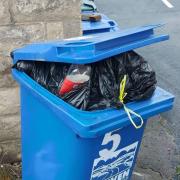 Blue, recyclng bin with wrong rubbish
