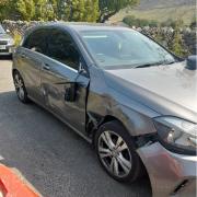 The damage sustained by a Mercedes parked on a narrow point in Burnsall