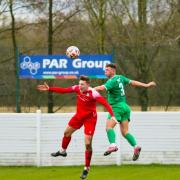 Barnoldswick (red) look to win a header against Charnock Richard on Saturday. Photo: Steven Taylor