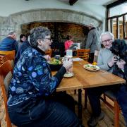 Folly Trustee Lynn greets a customer and her dog