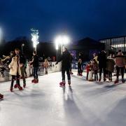 People enjoying  using an ice rink