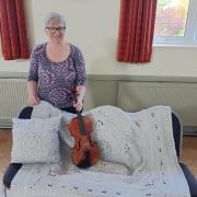Anne Heaton and her Sophie's Universe blanket and matching cushion