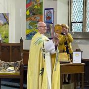 The Right Reverend Nick Baines, Bishop of Leeds, presenting the Eco Church Gold Award plaque